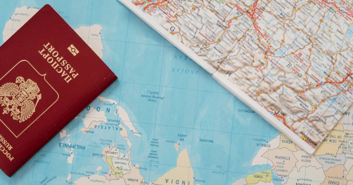 A passport resting on a world map, symbolising international travel planning for UK visa holders